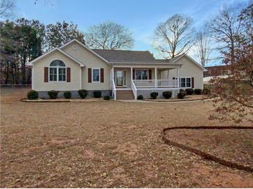 Charming single-story home featuring a cozy front porch and well-manicured landscaping at 21 Fortson Dr, Hampton, GA 30228