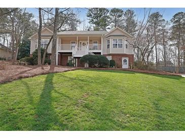 Charming two-story home with a covered front porch and a well-manicured lawn at 3114 Superior Dr, Dacula, GA 30019