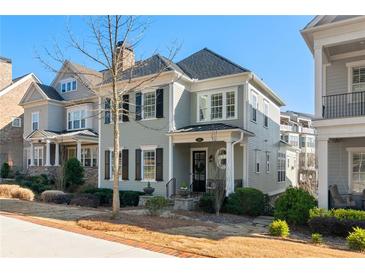 Charming two-story home with manicured lawn and inviting curb appeal on a bright day at 261 Thompson St, Alpharetta, GA 30009