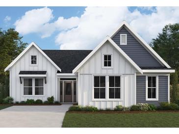 Charming two-story home featuring a mix of white and gray siding, complemented by large windows and a well-manicured lawn at 125 Laurel Farms Ln, Dallas, GA 30157