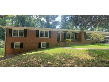 Charming brick home with well-maintained front yard and decorative iron porch columns at 3879 Artist Vw, Decatur, GA 30034