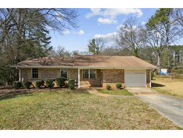 Charming brick ranch-style home with a single-car garage and well-maintained front yard at 2235 Chamois Ct, Decatur, GA 30035