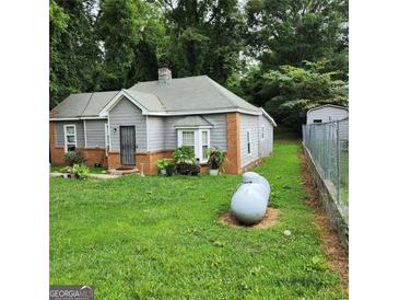 Charming single-story home with gray siding, brick accents, and a well-maintained front yard at 2516 Albert Way, Lithonia, GA 30058