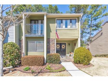 Charming two-story townhome with a balcony and well-maintained landscaping at 66 Goldrush Ne Cir, Atlanta, GA 30328