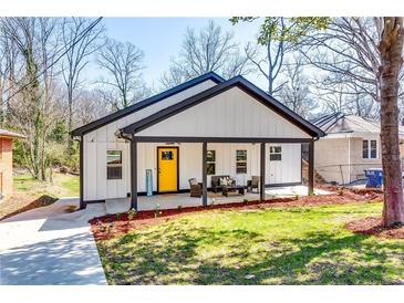Charming renovated home with a bright yellow door and covered front porch, perfect for relaxing at 236 Barfield Sw Ave, Atlanta, GA 30310