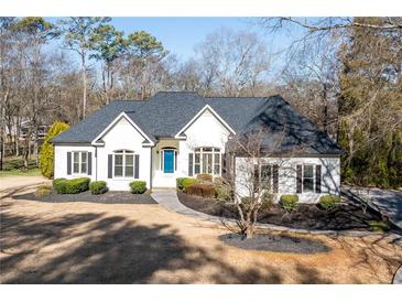 Charming single-story home with manicured lawn, blue door and dark shutters at 25 Sherman Nw Ln, Cartersville, GA 30121