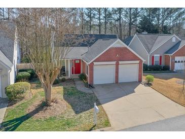 Charming single-story home with a brick facade, two-car garage, and well-maintained landscaping at 245 Dennis Dr, Alpharetta, GA 30009