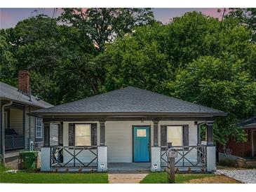 Charming home featuring a blue front door and inviting front porch with decorative railing at 872 Beryl Sw St, Atlanta, GA 30310