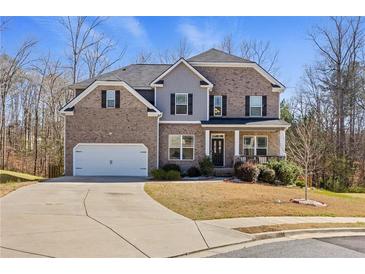 Charming two-story brick home with a well-maintained front yard and an inviting entrance at 1617 Matt Springs Dr, Lawrenceville, GA 30045