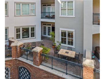 A beautiful multi-level patio with brick flooring, wrought iron railings, and an outdoor table and chairs set at 11 Perimeter E Ctr # 1115, Atlanta, GA 30346