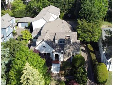 Charming home with lush landscaping, brick chimney, and detached garage at 1666 Johnson Ne Rd, Atlanta, GA 30306