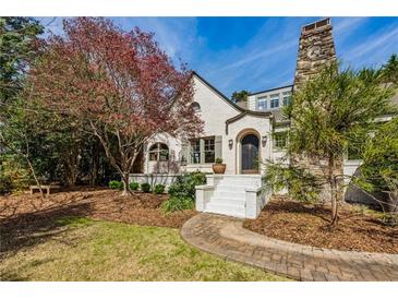 Charming home with stone chimney, brick walkway, and fresh landscaping at 1666 Johnson Ne Rd, Atlanta, GA 30306