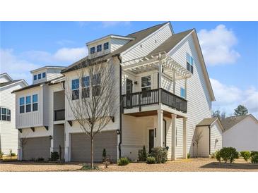 Beautiful two-story home featuring white siding, a balcony, and a two-car garage at 4414 Declan Dr, Kennesaw, GA 30144