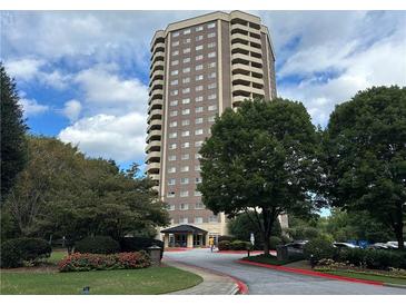 Tall apartment building showing entrance and surrounding greenery on partly cloudy day at 1501 Clairmont Rd # 2016, Decatur, GA 30033