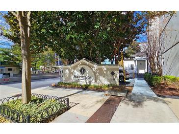 Community sign and entrance to Peachtree Walk Condominiums with landscaping at 1074 Peachtree Sw Walk # B 216, Atlanta, GA 30309