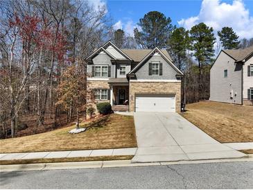 Charming two-story home with stone accents, a well-manicured lawn, and an attached two-car garage at 134 Jacobs Ln, Loganville, GA 30052