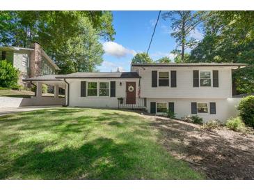 Charming two-story home featuring a well-manicured lawn, a covered side-entry carport, and classic shutters at 2793 Frontier Trl, Atlanta, GA 30341