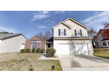 Charming two-story home with a well-maintained lawn and two-car garage at 2357 Wellborn Hills Pl, Lithonia, GA 30058