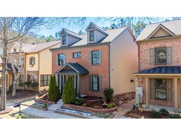 Charming brick home featuring a cozy front porch and well-manicured landscaping at 3780 Baxley Pine Trl, Suwanee, GA 30024