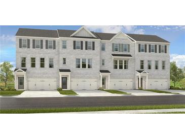 New construction townhome with gray brick, black shutters, and individual garage entries at 5841 Schelton Se Pl, Mableton, GA 30126