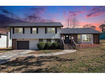 Charming two-story home with a brick and siding exterior and a well-maintained front yard at 5419 Golfcrest Cir, Stone Mountain, GA 30088