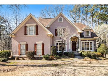 Charming two-story home with a manicured lawn and traditional architectural details at 4559 Cabinwood Turn, Douglasville, GA 30135