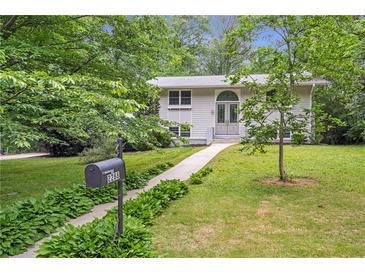 Charming single-Gathering home featuring a manicured lawn, mature trees, and a lovely walkway to the front door at 2288 Street Deville Ne, Atlanta, GA 30345