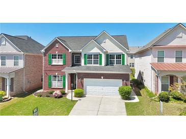 Charming brick home with green shutters, manicured lawn, and two-car garage at 5819 Rue Chase Way, Tucker, GA 30084