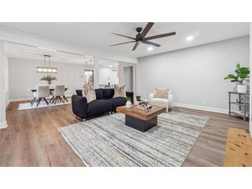 Spacious living room featuring modern furnishings and an open floor plan to the dining area at 1849 S Columbia Place, Decatur, GA 30032