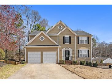 Charming two-story home featuring a well-manicured front yard, two-car garage, and classic architectural details at 4283 Brighton Nw Way, Kennesaw, GA 30144