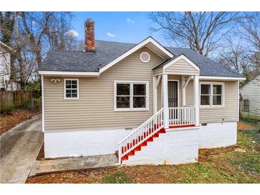 Charming home featuring a painted brick foundation, red stairs, and a quaint covered front porch at 2370 Mcafee Rd, Decatur, GA 30032