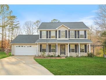 Charming two-story home with a well-manicured lawn and inviting front porch at 745 Trickle Ln, Mcdonough, GA 30252