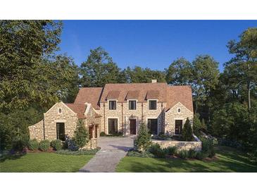 Beautiful stone home with manicured lawn and mature trees offers classic elegance and curb appeal at 41 Blackland Nw Rd, Atlanta, GA 30342