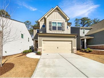 Charming two-story home featuring a two-car garage and well-maintained front yard with a freshly poured concrete drive way at 3671 Salvia Dr, Buford, GA 30519