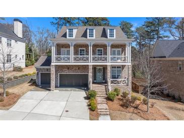 Charming two-story brick home with a welcoming front porch and well-manicured landscaping at 4535 Atley Woods Se Dr, Atlanta, GA 30339