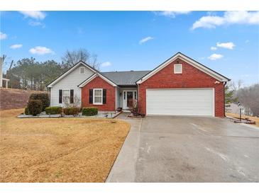 Charming single-story home featuring a brick facade, two-car garage, and well-maintained lawn at 1760 Campbell Ives Dr, Lawrenceville, GA 30045
