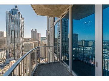 Enjoy the city views from this condo balcony with sliding glass doors and metal railings at 400 W Peachtree Nw St # 3412, Atlanta, GA 30308