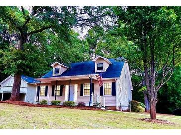 Charming home with a welcoming front porch and mature trees at 410 Invector Ct, Locust Grove, GA 30248