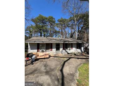 Cozy single-story home featuring a simple design, and a well-worn driveway leading to the entrance at 3382 Phillips Cir, Decatur, GA 30032