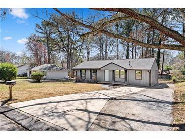 Charming single-story home with a well-maintained front yard and a long driveway at 8329 Marlborough Dr, Jonesboro, GA 30238