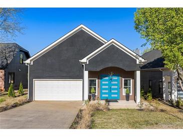 Charming one-story home featuring a striking blue front door and modern architectural details at 1041 Walker Se Ave, Atlanta, GA 30316