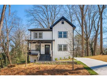 Charming two-story modern farmhouse with white siding, black trim, covered porch, and well-manicured landscaping at 2860 3Rd Sw Ave, Atlanta, GA 30315
