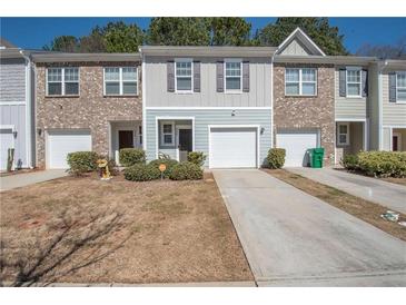 Inviting townhome with a one-car garage and well-maintained front yard at 6338 Kinsland Ct, Lithonia, GA 30058
