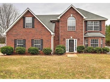 Charming two-story brick home featuring a manicured front lawn and traditional architectural details at 4871 Ship Jack Ln, Decatur, GA 30035
