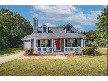 Charming single-story home featuring a manicured lawn and a bright red front door at 1743 Wee Kirk Se Rd, Atlanta, GA 30316