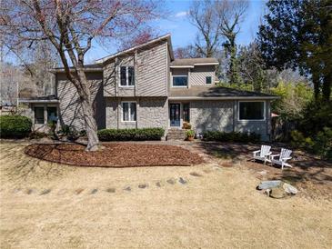 Beautiful two-story home with a well-manicured front yard and stone accents at 3261 Turtle Lake Se Ct, Marietta, GA 30067