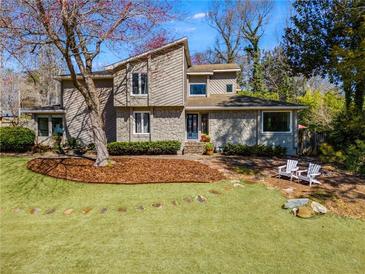 Charming home featuring a landscaped front yard with stone accents and a welcoming entrance at 3261 Turtle Lake Se Ct, Marietta, GA 30067