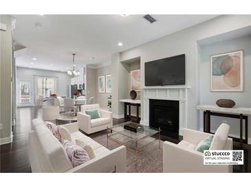 Bright living room featuring a fireplace, modern decor, and seamless open-concept design at 1829 Hislop Ln, Atlanta, GA 30345