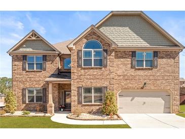 Charming two-story brick home with well-manicured lawn and inviting curb appeal at 3314 Ridge Manor Way, Dacula, GA 30019