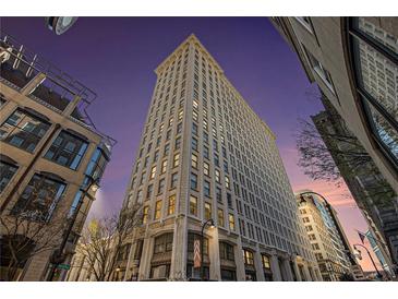 Striking low angle view of the tall building showing the facade and surrounding street at dusk at 57 Forsyth Nw St # 16D, Atlanta, GA 30303